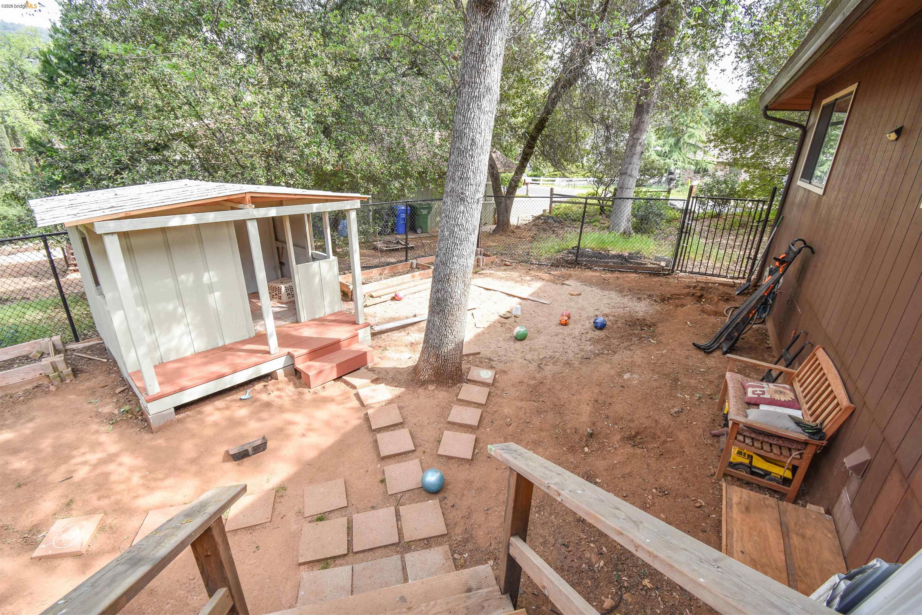 15 Roble Road Sonora, CA 95370 - Photo 42 of 44 Fenced backyard with a storage shed and a game area
