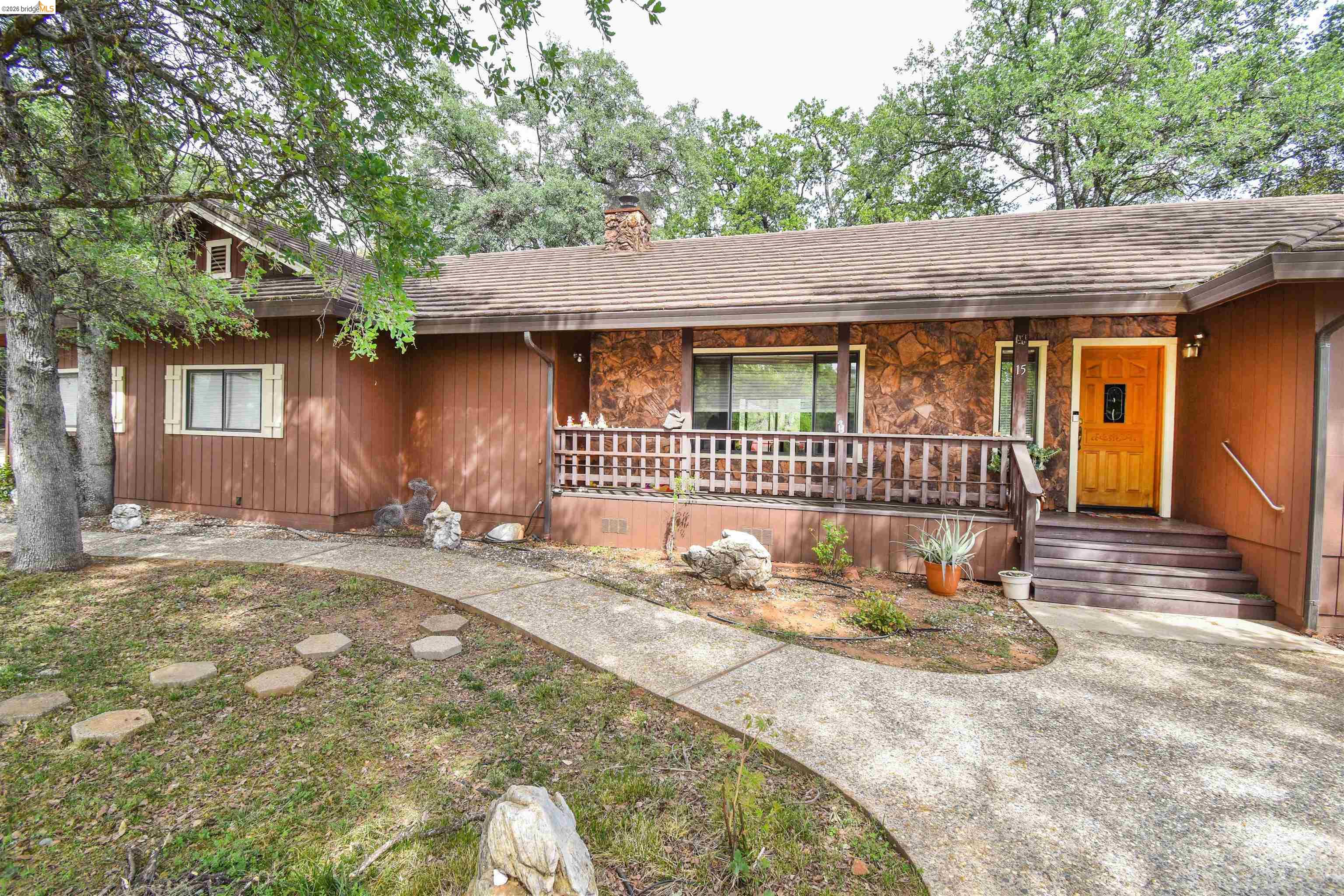 15 Roble Road Sonora, CA 95370 - Photo 5 of 44 View of front of property featuring covered porch, stone siding, and a chimney