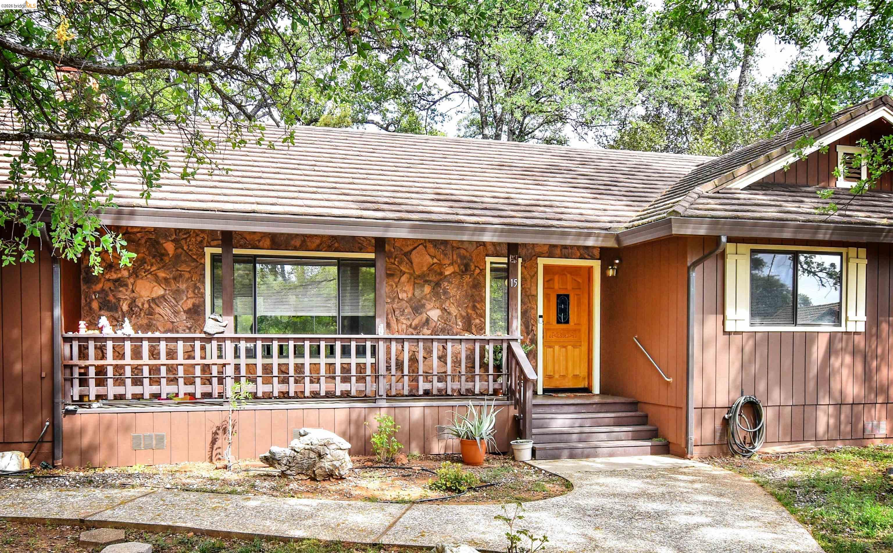 15 Roble Road Sonora, CA 95370 - Photo 6 of 44 View of front of house featuring stone siding and a porch