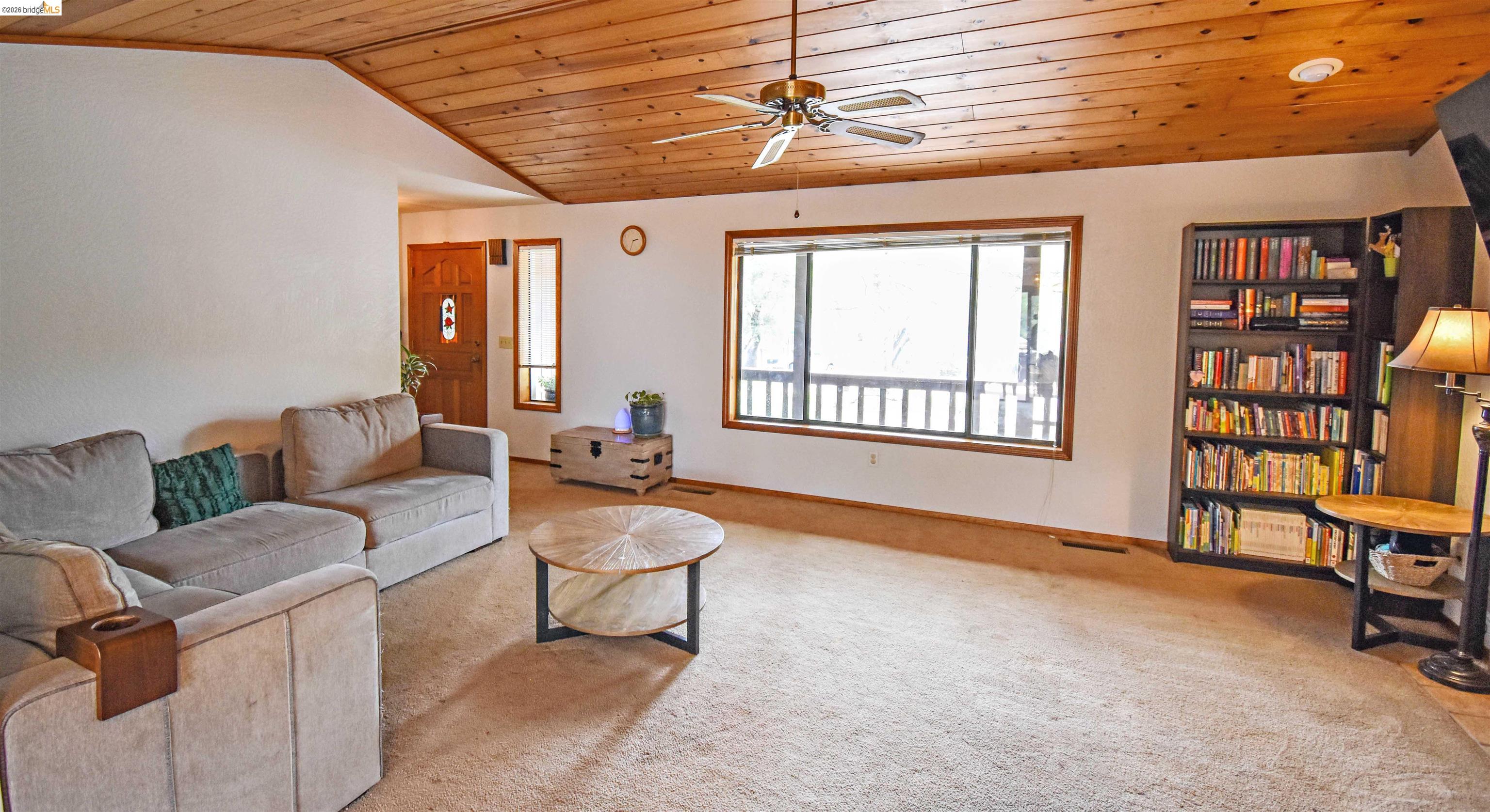 15 Roble Road Sonora, CA 95370 - Photo 10 of 44 Living room featuring a vaulted wood ceiling, a ceiling fan, and light carpet