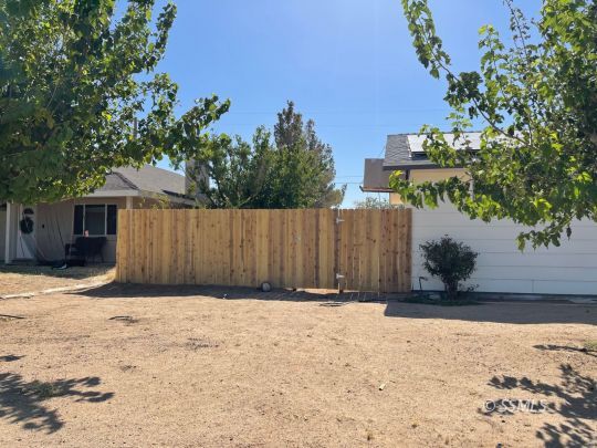 1521 South McCall Street Ridgecrest, CA 93555 - Photo 38 of 39 a view of wooden fence under a large tree