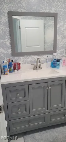 a bathroom with a sink and a mirror