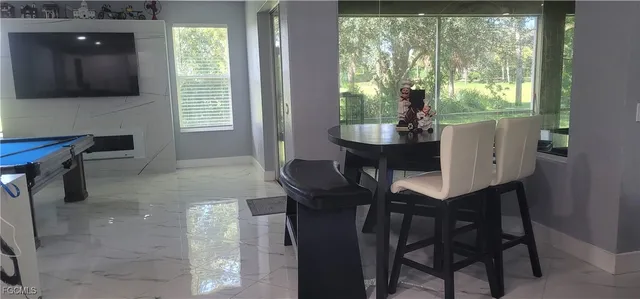 a living room with a fireplace and a flat screen tv