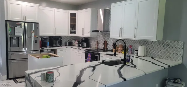 a bedroom with a bed and large windows