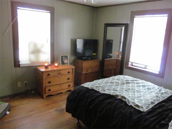 144 Podunk Road Sturbridge, MA 01566 - Photo 5 of 8 a bedroom with a bed and a flat tv screen on dresser