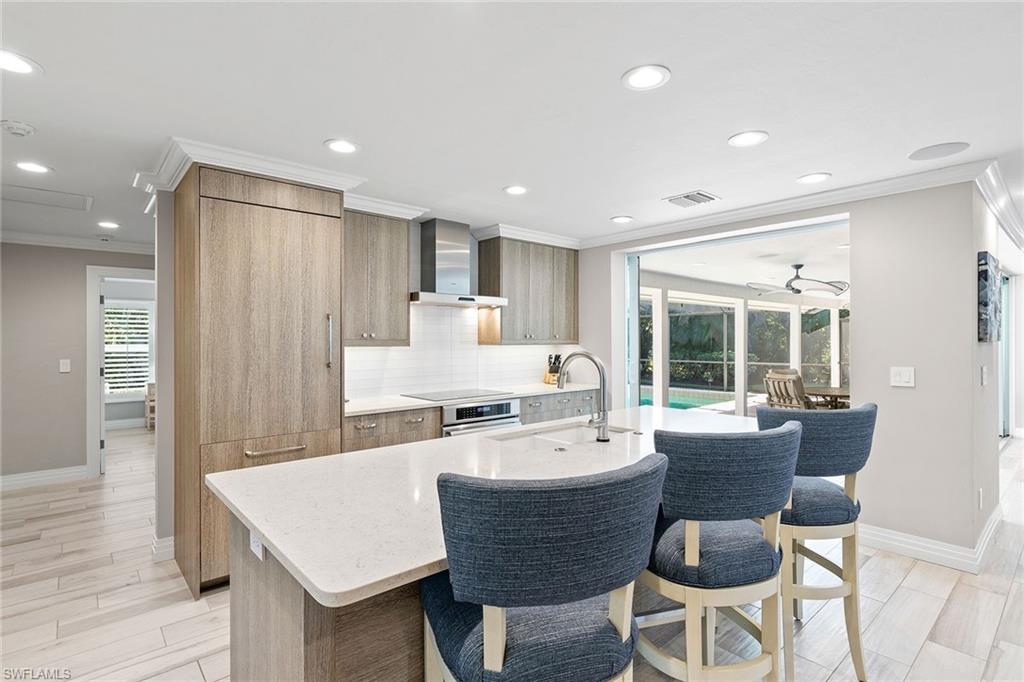 3720 Parkview Way Naples, FL 34103 - Photo 11 of 27 a large kitchen with a table and chairs