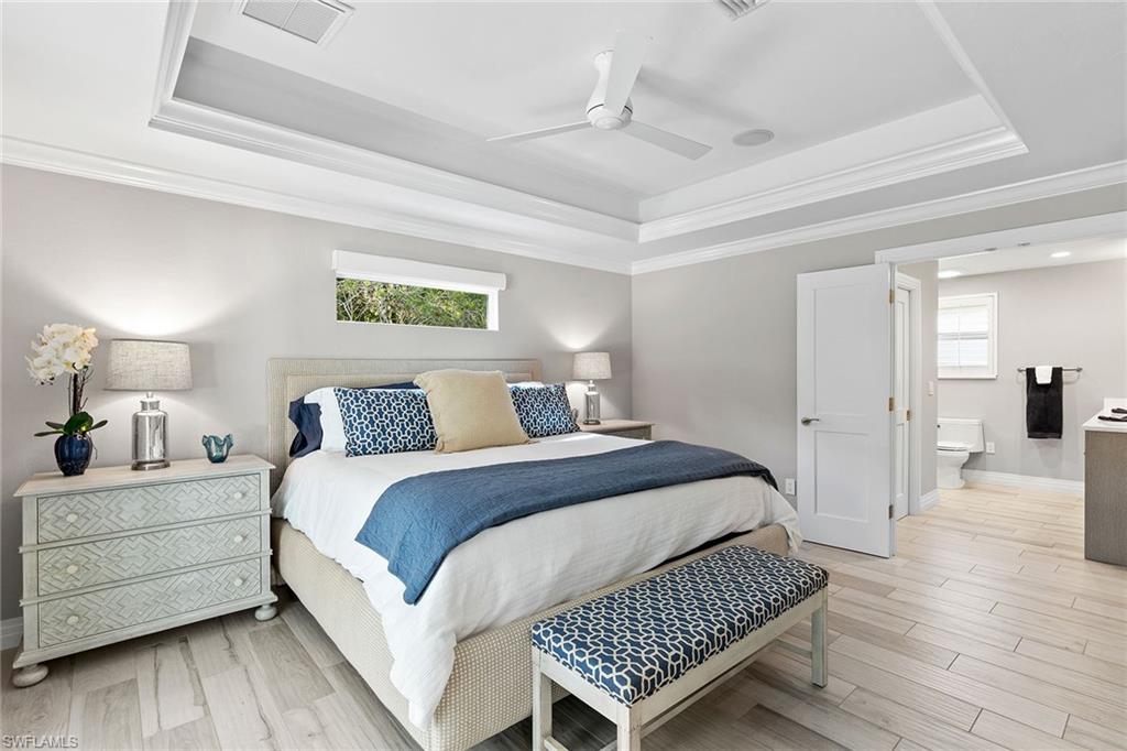 3720 Parkview Way Naples, FL 34103 - Photo 16 of 27 a bedroom with a bed and wooden floor