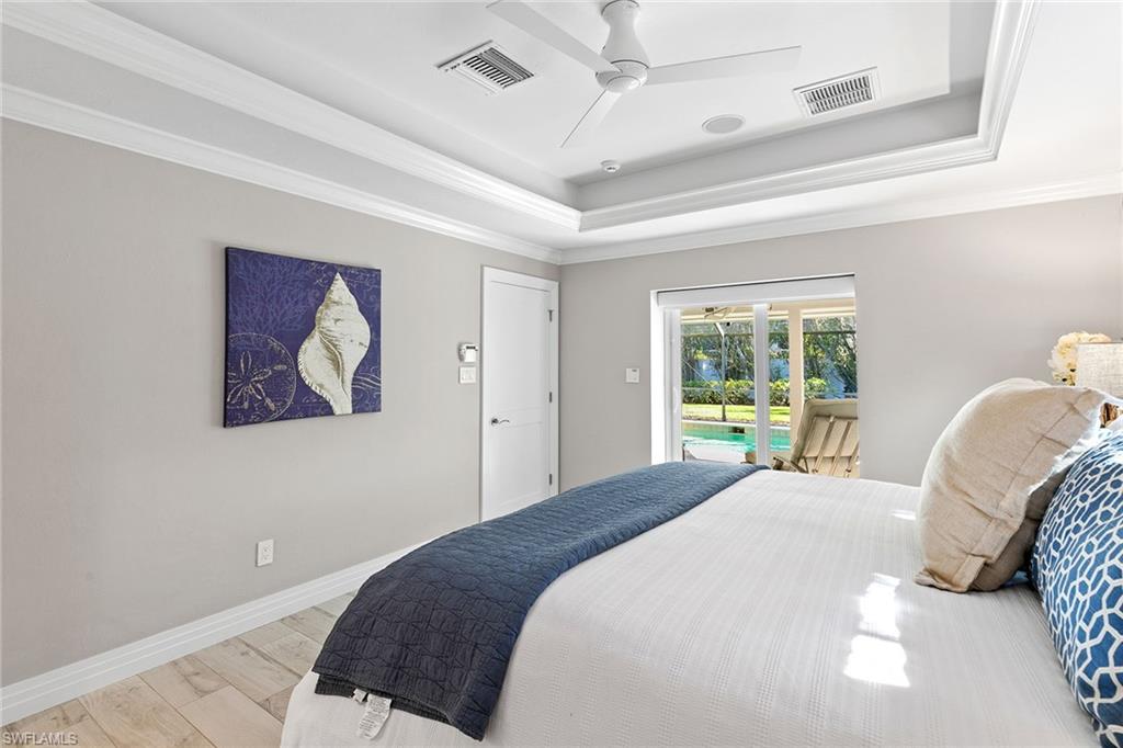 3720 Parkview Way Naples, FL 34103 - Photo 17 of 27 a bedroom with a bed and a painting on the wall