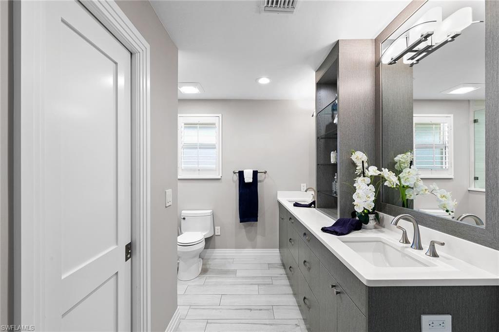 3720 Parkview Way Naples, FL 34103 - Photo 18 of 27 a bathroom with a double vanity sink and a mirror