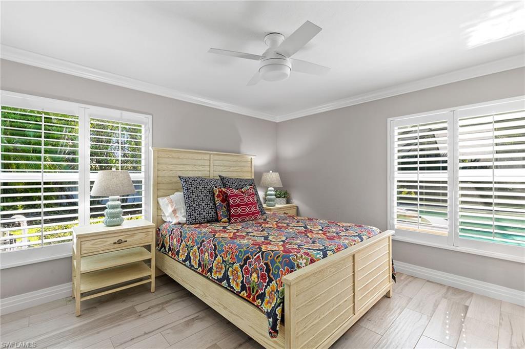 3720 Parkview Way Naples, FL 34103 - Photo 19 of 27 a bedroom with a large bed and a window