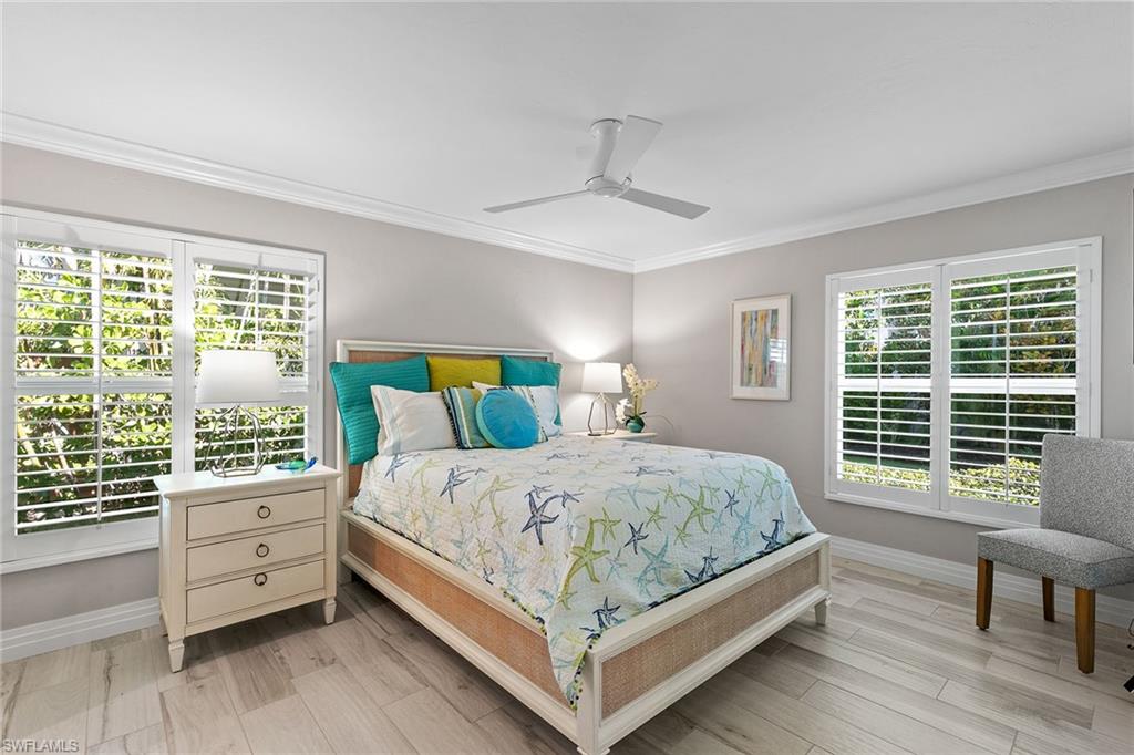 3720 Parkview Way Naples, FL 34103 - Photo 22 of 27 a bedroom with a large bed and a window