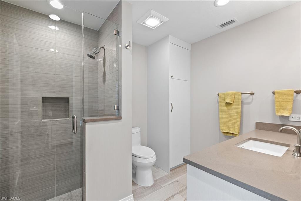 3720 Parkview Way Naples, FL 34103 - Photo 23 of 27 a bathroom with a granite countertop sink a toilet and shower