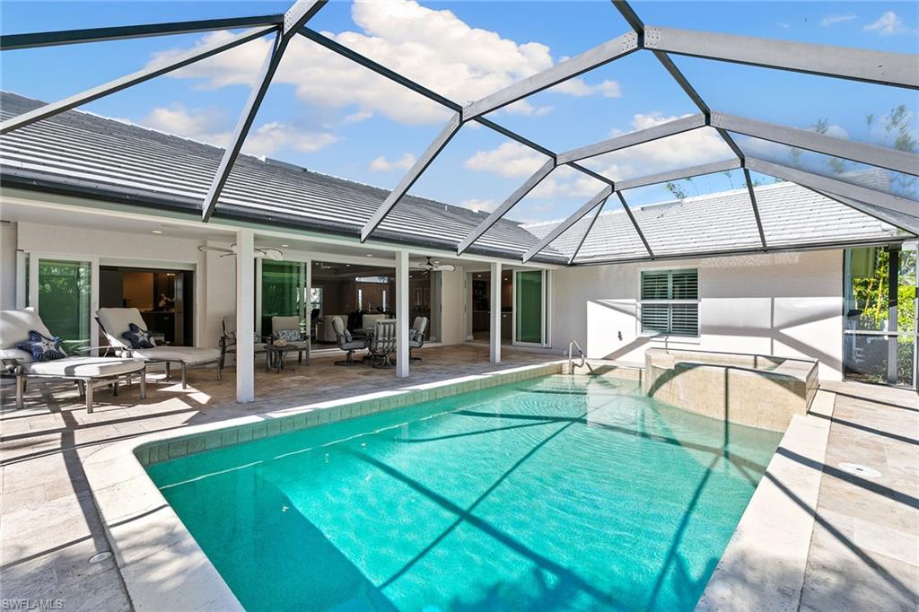 3720 Parkview Way Naples, FL 34103 - Photo 24 of 27 a view of a patio with a table and chairs under an umbrella