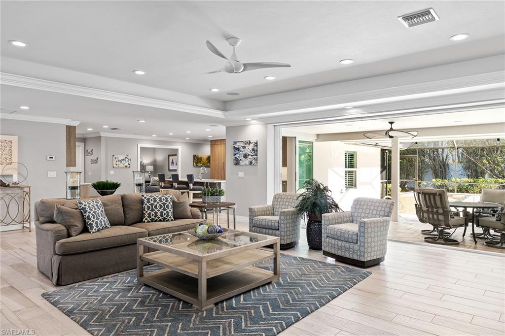 3720 Parkview Way Naples, FL 34103 - Photo 4 of 27 a living room with furniture and a table