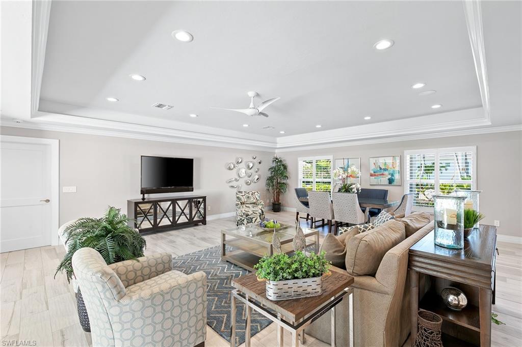 3720 Parkview Way Naples, FL 34103 - Photo 5 of 27 a living room with furniture a flat screen tv and a large window