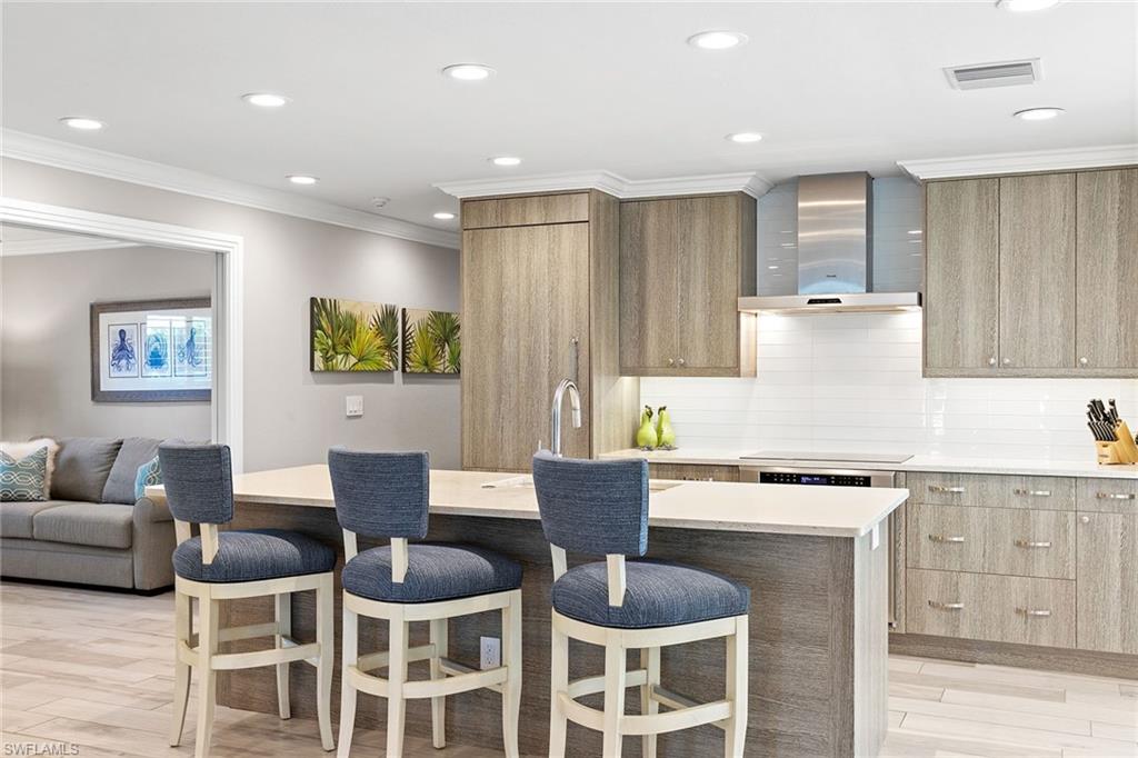 3720 Parkview Way Naples, FL 34103 - Photo 9 of 27 a kitchen with a dining table cabinets and chairs