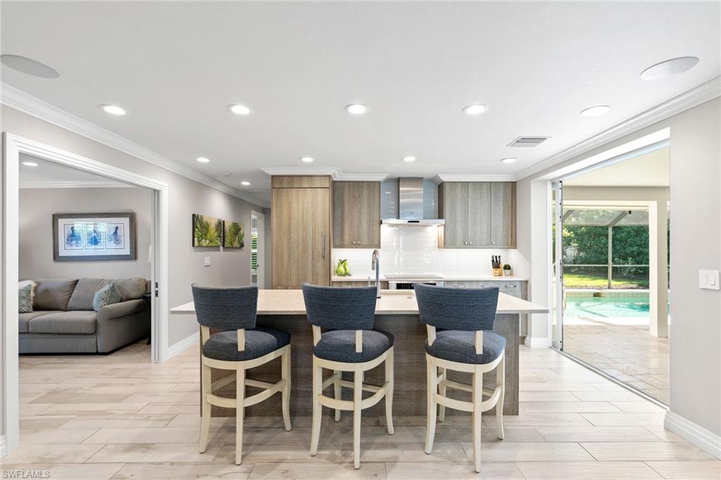 3720 Parkview Way Naples, FL 34103 - Photo 10 of 27 a view of a dining room with furniture a rug and wooden floor