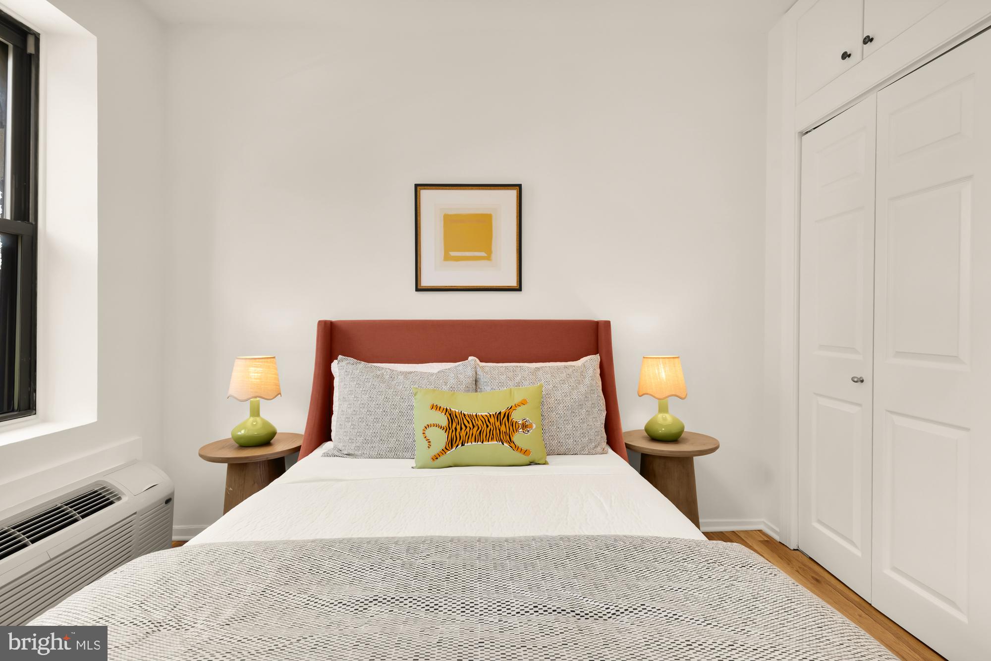 1844 Columbia Road Northwest, Unit 301 Washington, DC 20009 - Photo 11 of 21 a bedroom with a bed and wooden floor