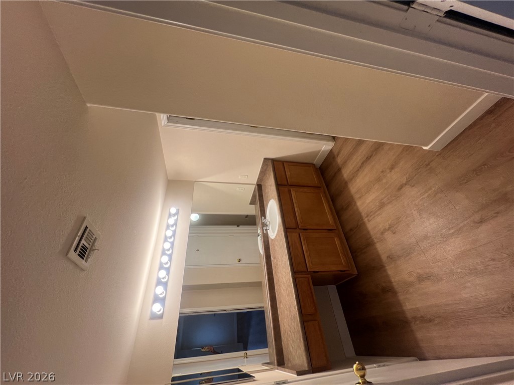 7255 West Sunset Road, Unit 2057 Las Vegas, NV 89113 - Photo 3 of 12 A warm wooden vanity with dual sinks graces this well-appointed bathroom.