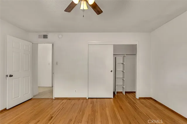 a view of an empty room and wooden floor