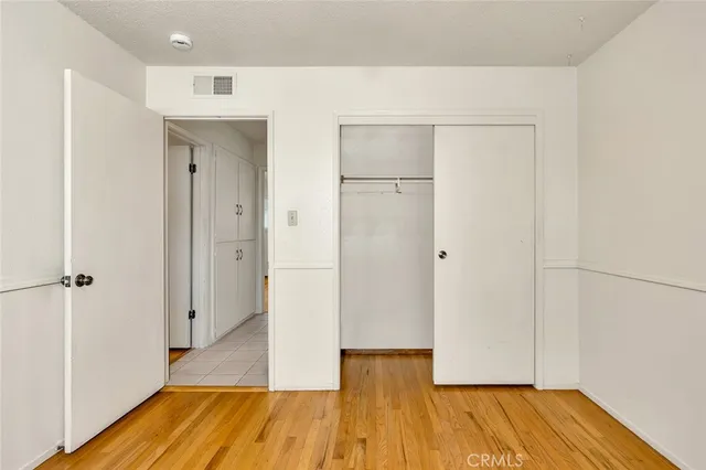 a view of a room with wooden floor and a bathroom