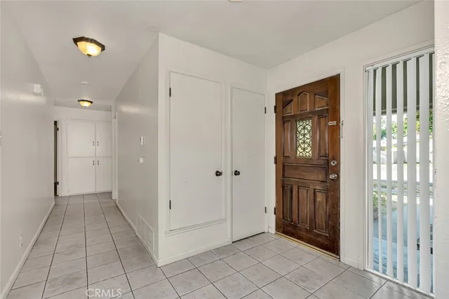 a view of a hallway with wooden floor and windows