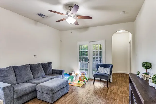 a living room with furniture and wooden floor