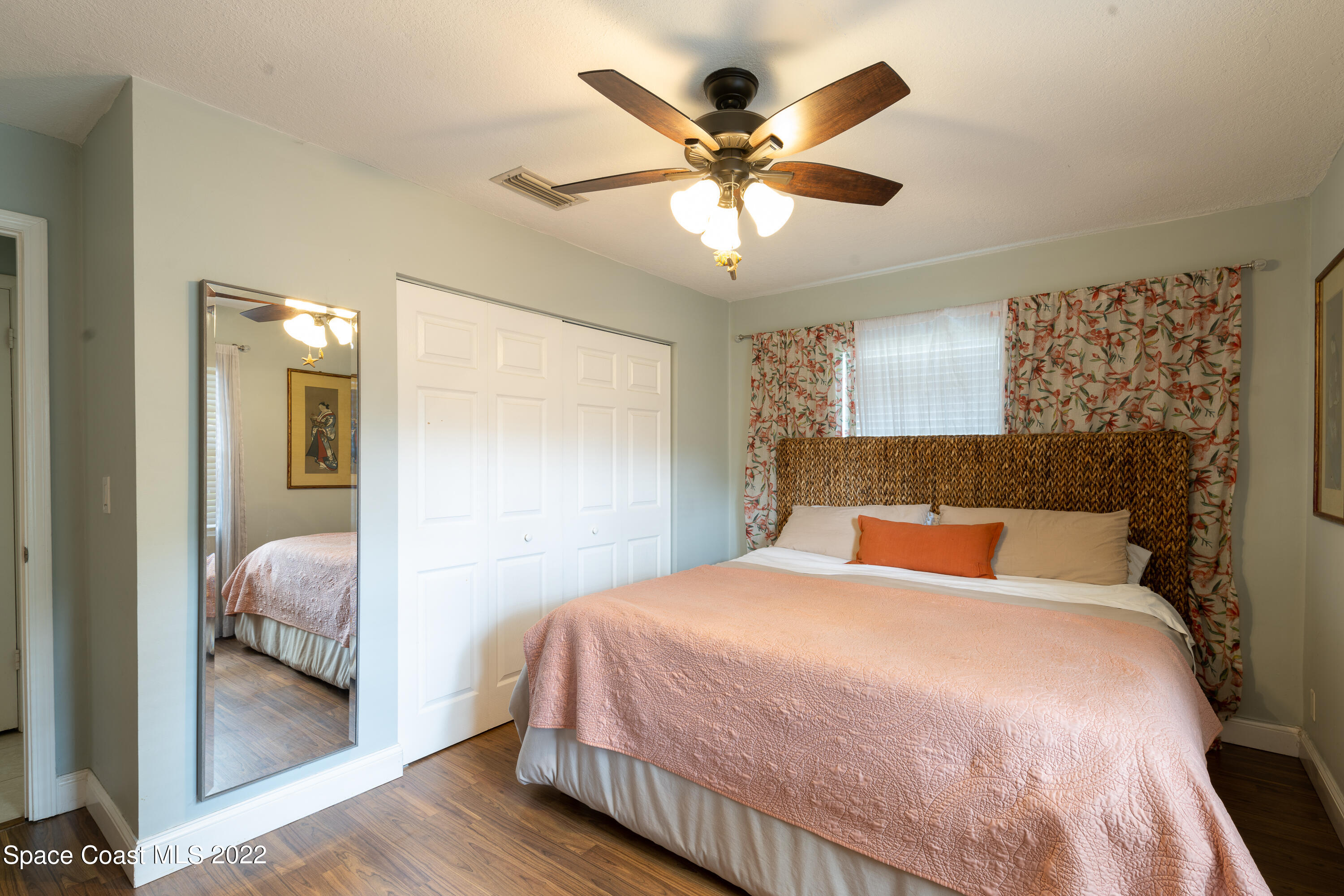 115 Dory Road St. Augustine, FL 32086 - Photo 12 of 31 a bedroom with a large bed and a chandelier