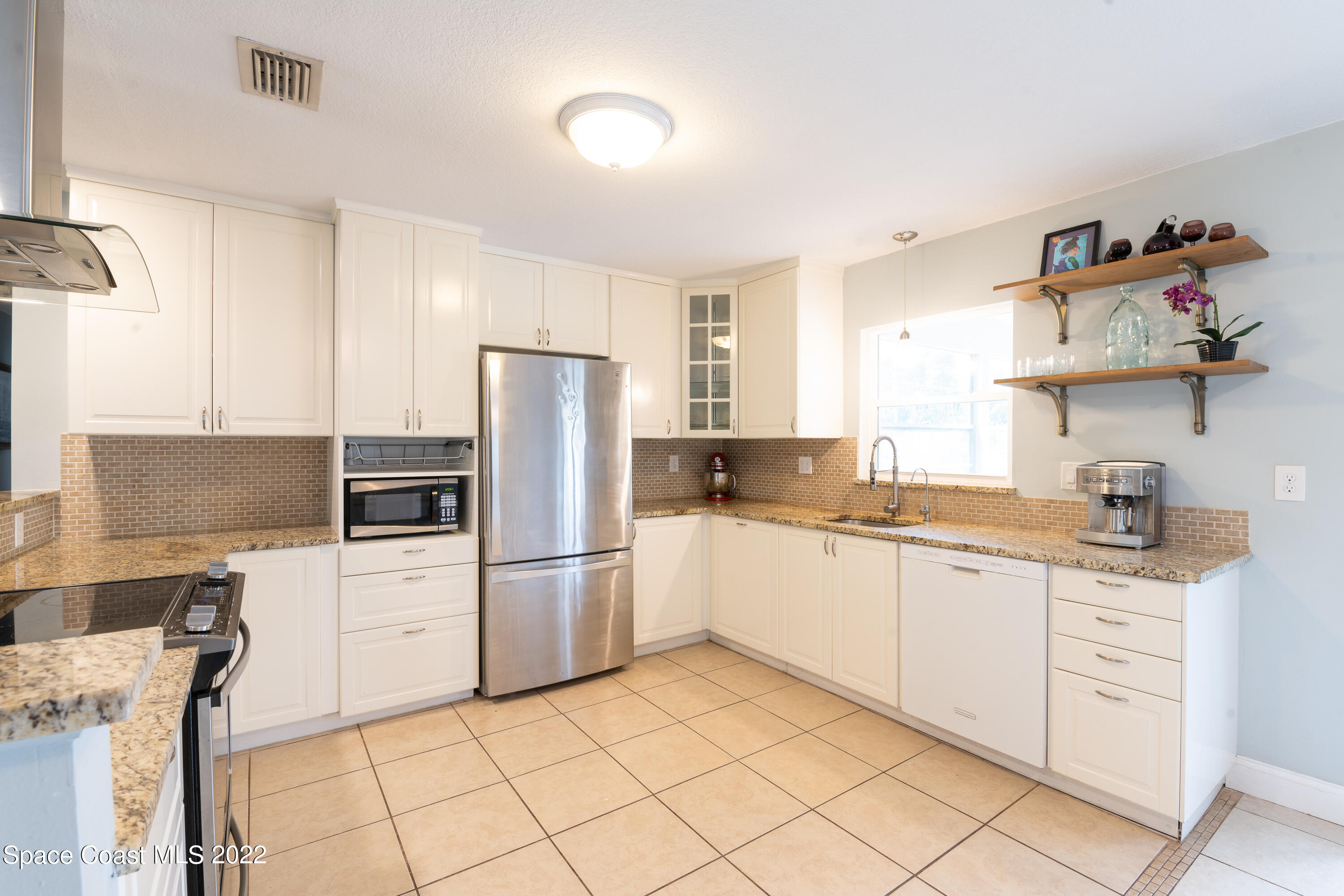 115 Dory Road St. Augustine, FL 32086 - Photo 15 of 31 a kitchen with granite countertop cabinets and steel stainless steel appliances