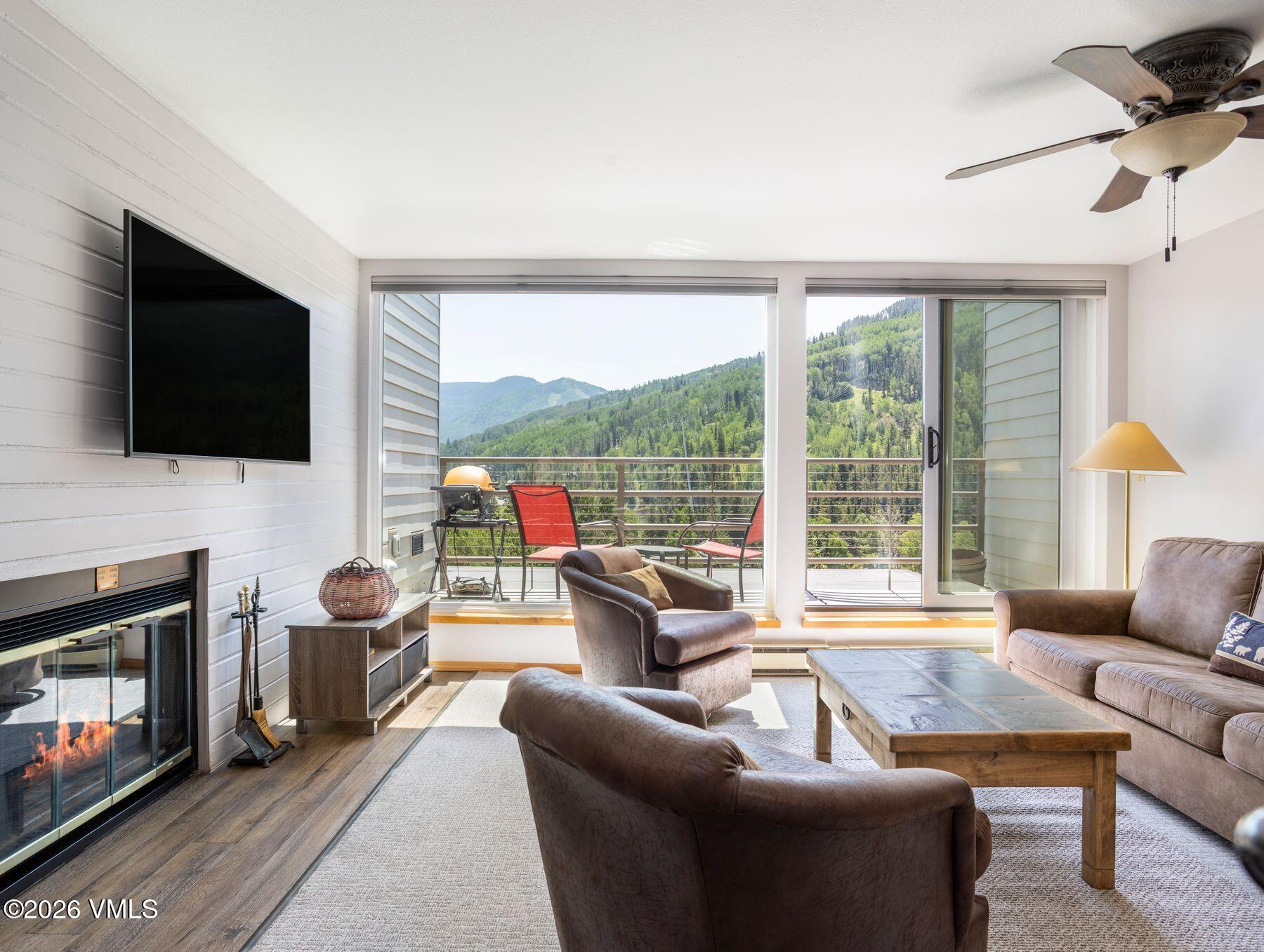 1100 North Frontage Road West, Unit 1503 Vail, CO 81657 - Photo 3 of 32 a living room with fireplace furniture and a flat screen tv