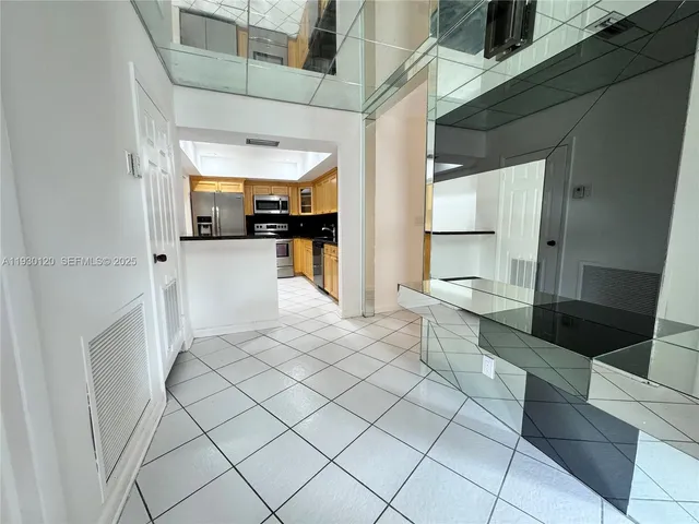 a spacious bathroom with a granite countertop sink a mirror and a shower