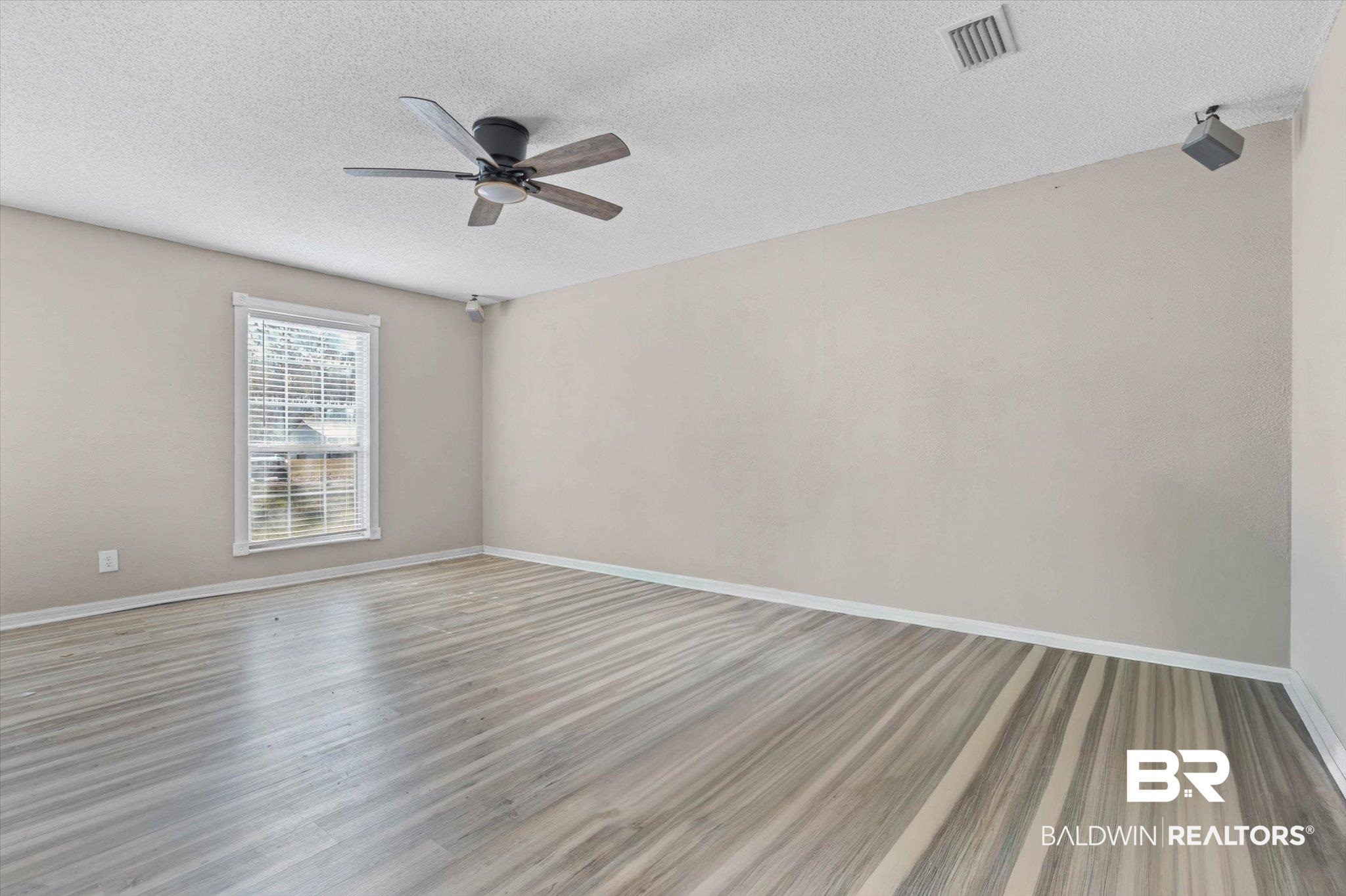 180 Creax Road Axis, AL 36505 - Photo 19 of 35 Spare room featuring a textured ceiling, wood finished floors, and ceiling fan
