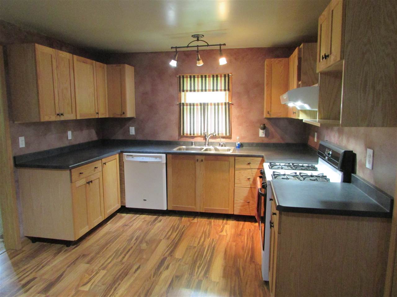 504 Barry Road Rockford, IL 61109 - Photo 11 of 31 a kitchen with kitchen island granite countertop a sink cabinets and wooden floor