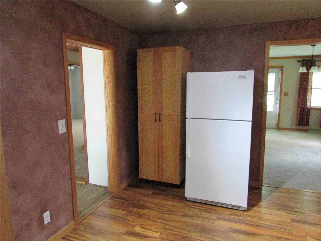 504 Barry Road Rockford, IL 61109 - Photo 13 of 31 a view of a refrigerator in kitchen and an empty room