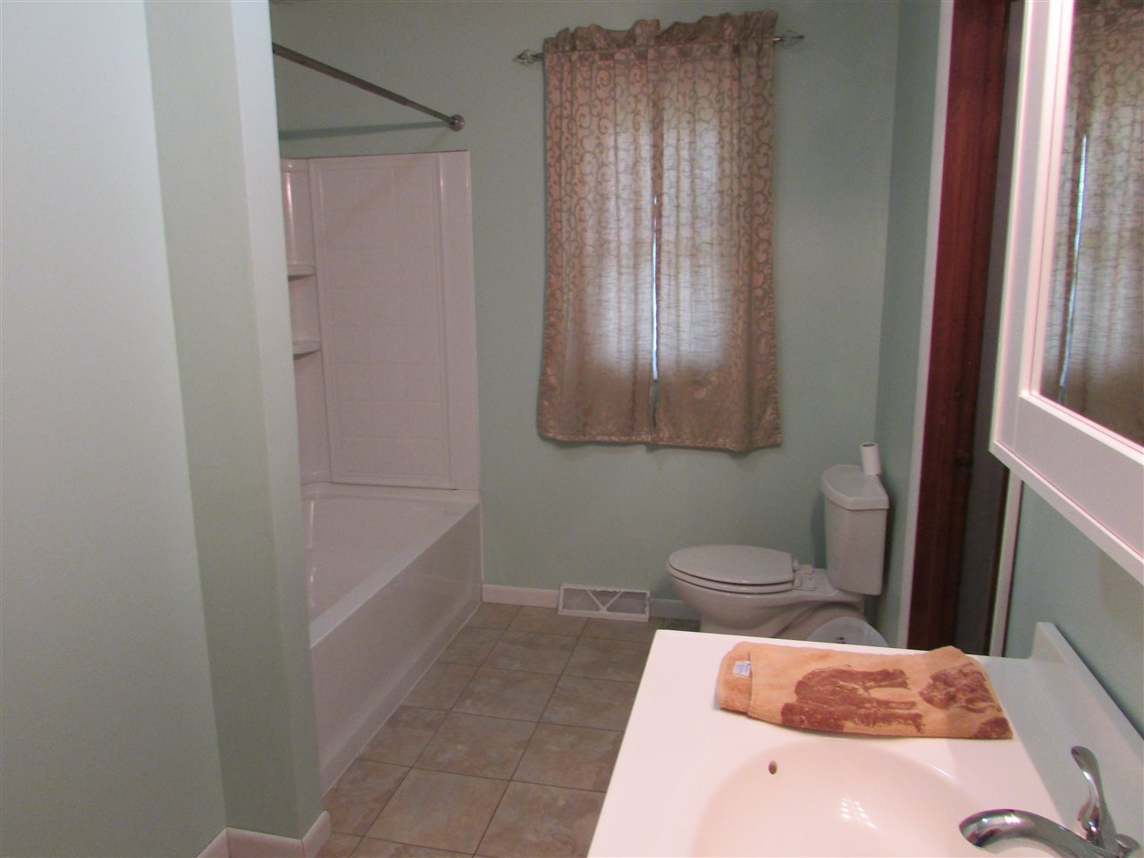 504 Barry Road Rockford, IL 61109 - Photo 19 of 31 a bathroom with a toilet and a sink
