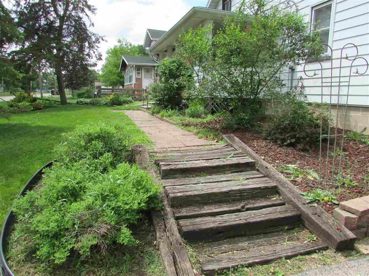504 Barry Road Rockford, IL 61109 - Photo 2 of 31 a view of a garden with a bench