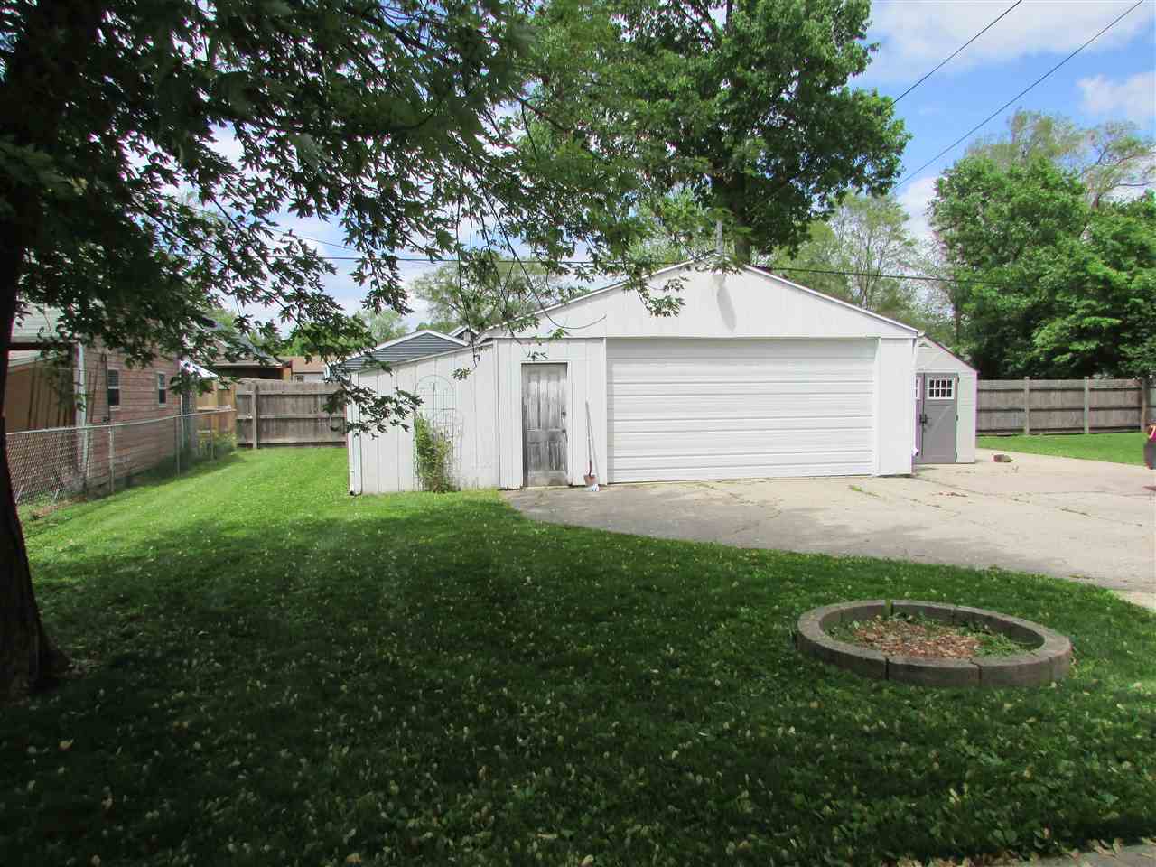 504 Barry Road Rockford, IL 61109 - Photo 26 of 31 a view of a backyard with table and chairs and a fire pit