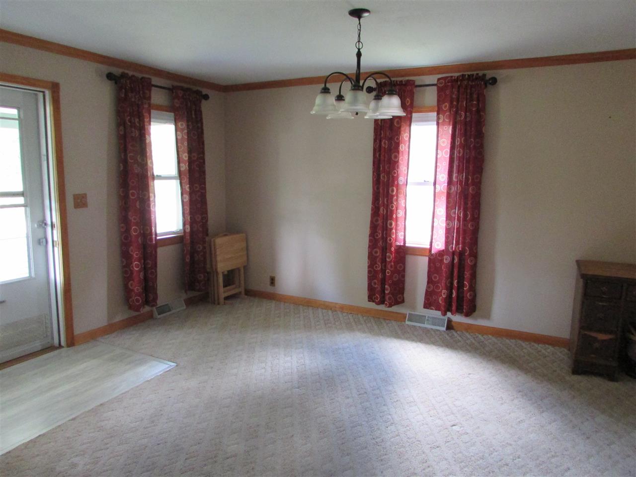 504 Barry Road Rockford, IL 61109 - Photo 3 of 31 an empty room with windows and chandelier fan