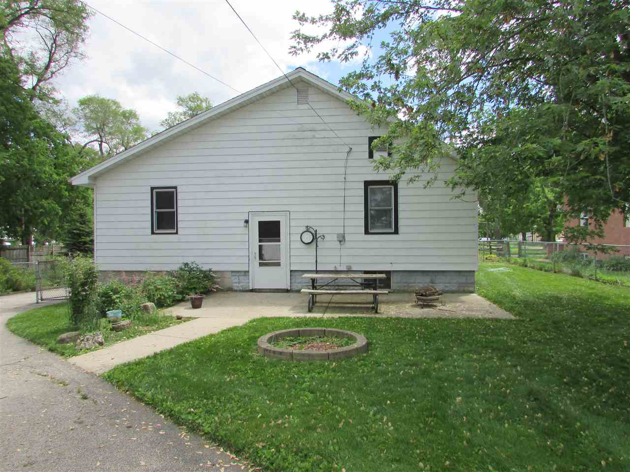 504 Barry Road Rockford, IL 61109 - Photo 31 of 31 a view of a backyard with table and chairs potted plants and large tree