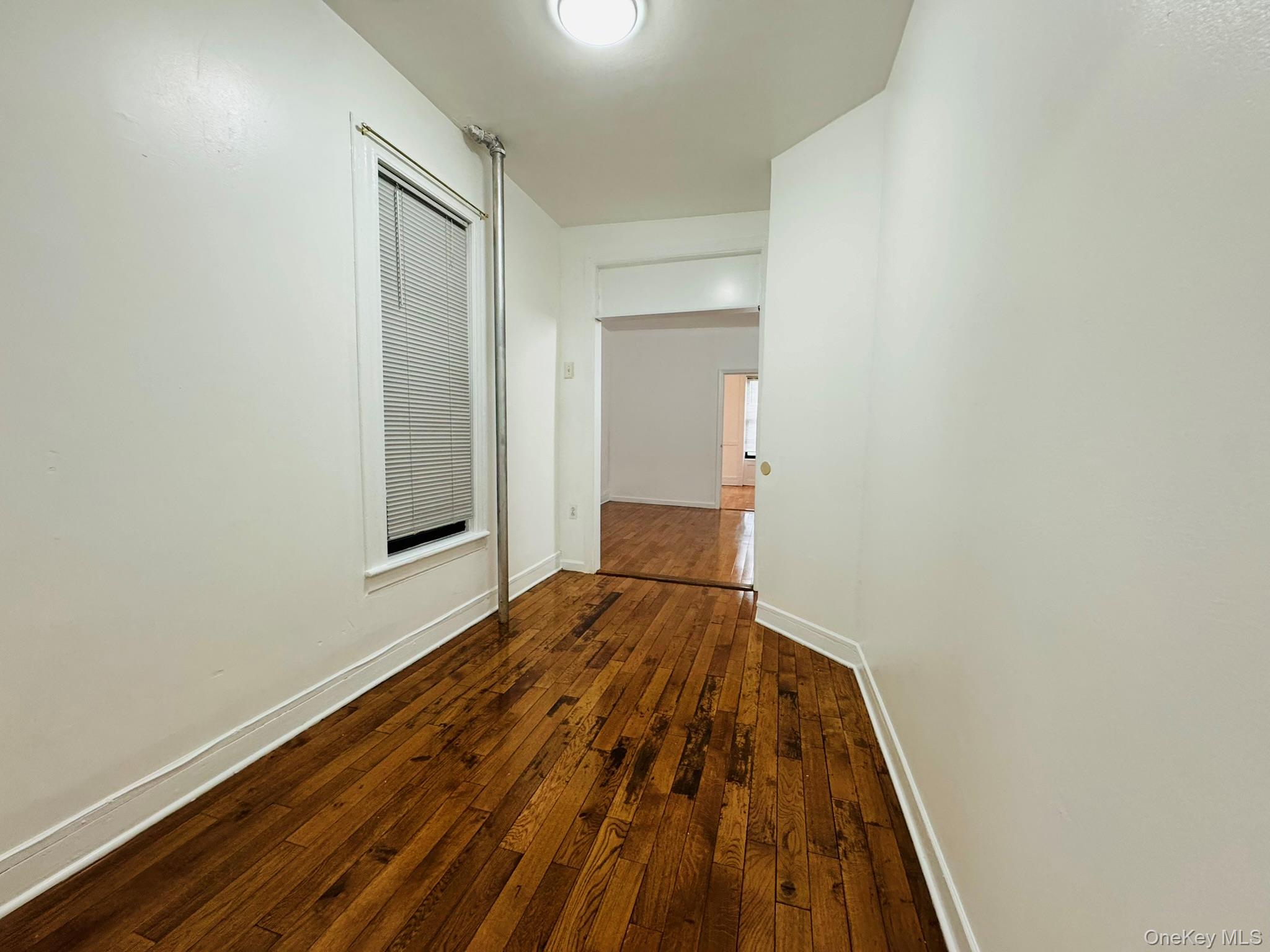 25-38 22nd Street, Unit 1 Queens, NY 11102 - Photo 11 of 19 a bedroom with a bed and wooden floor