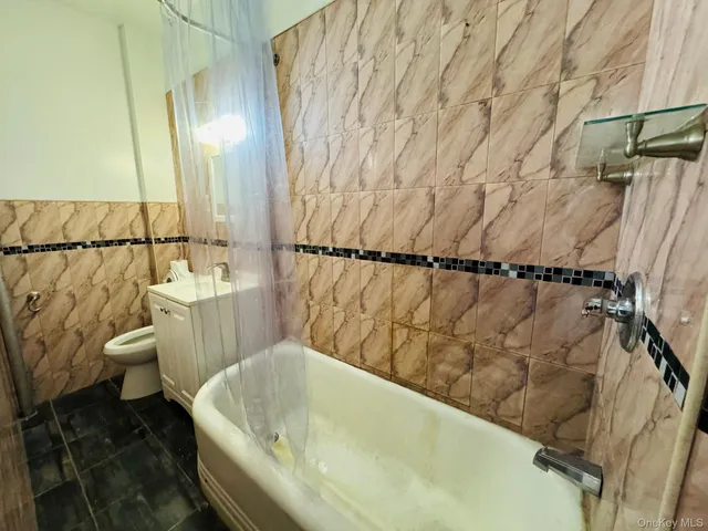 a bathroom with a bathtub and shower