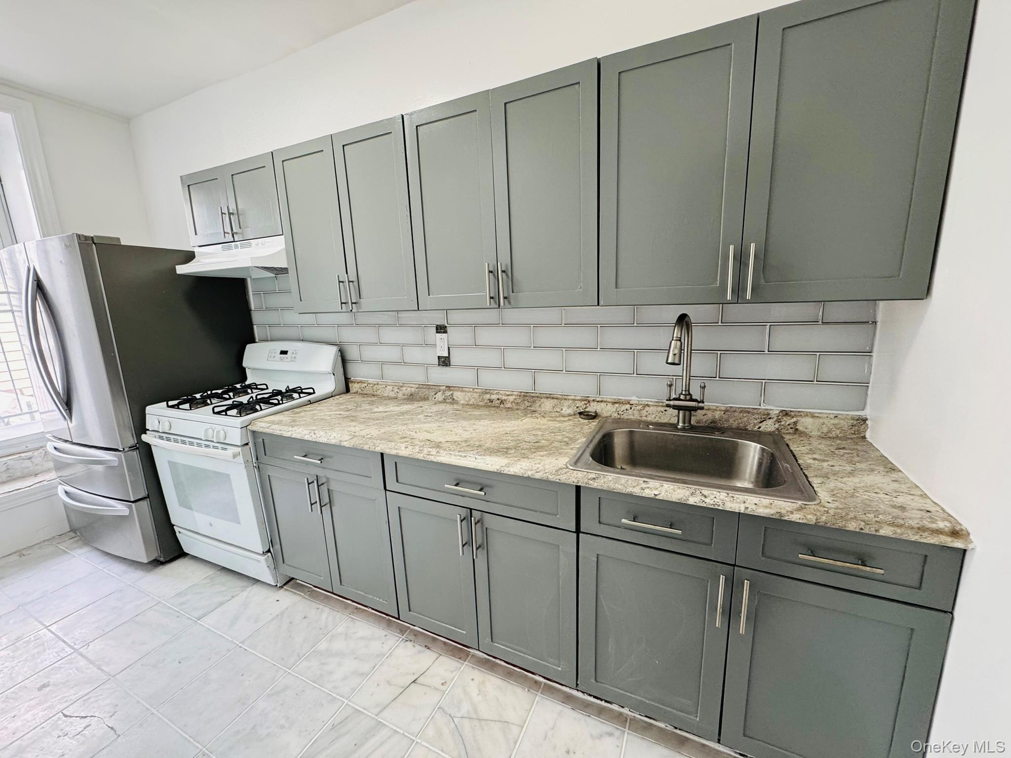 25-38 22nd Street, Unit 1 Queens, NY 11102 - Photo 19 of 19 a kitchen with a sink and cabinets