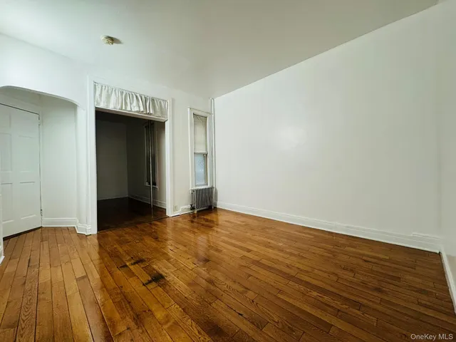 a view of an empty room and wooden floor