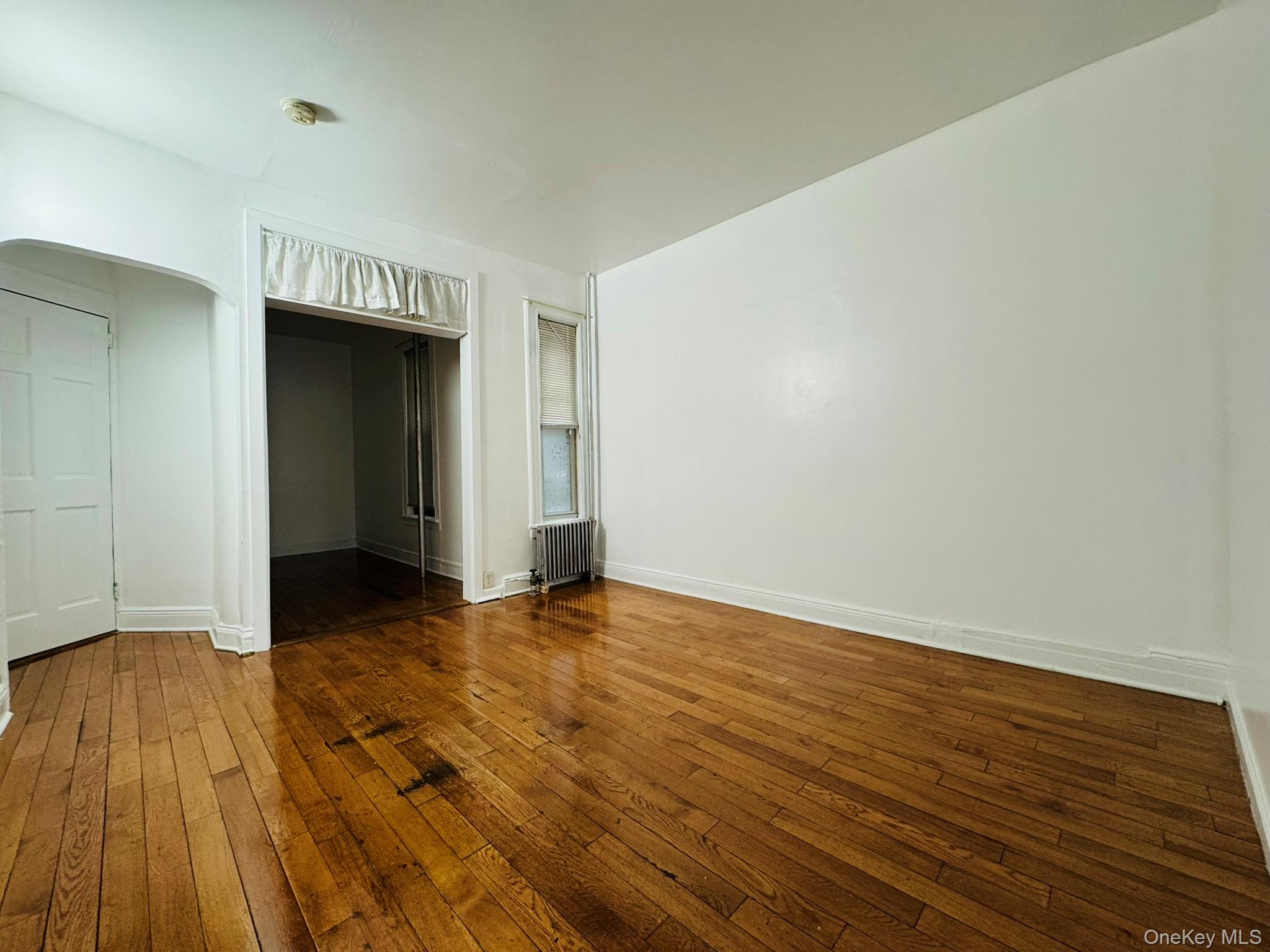 25-38 22nd Street, Unit 1 Queens, NY 11102 - Photo 2 of 19 a view of an empty room and wooden floor