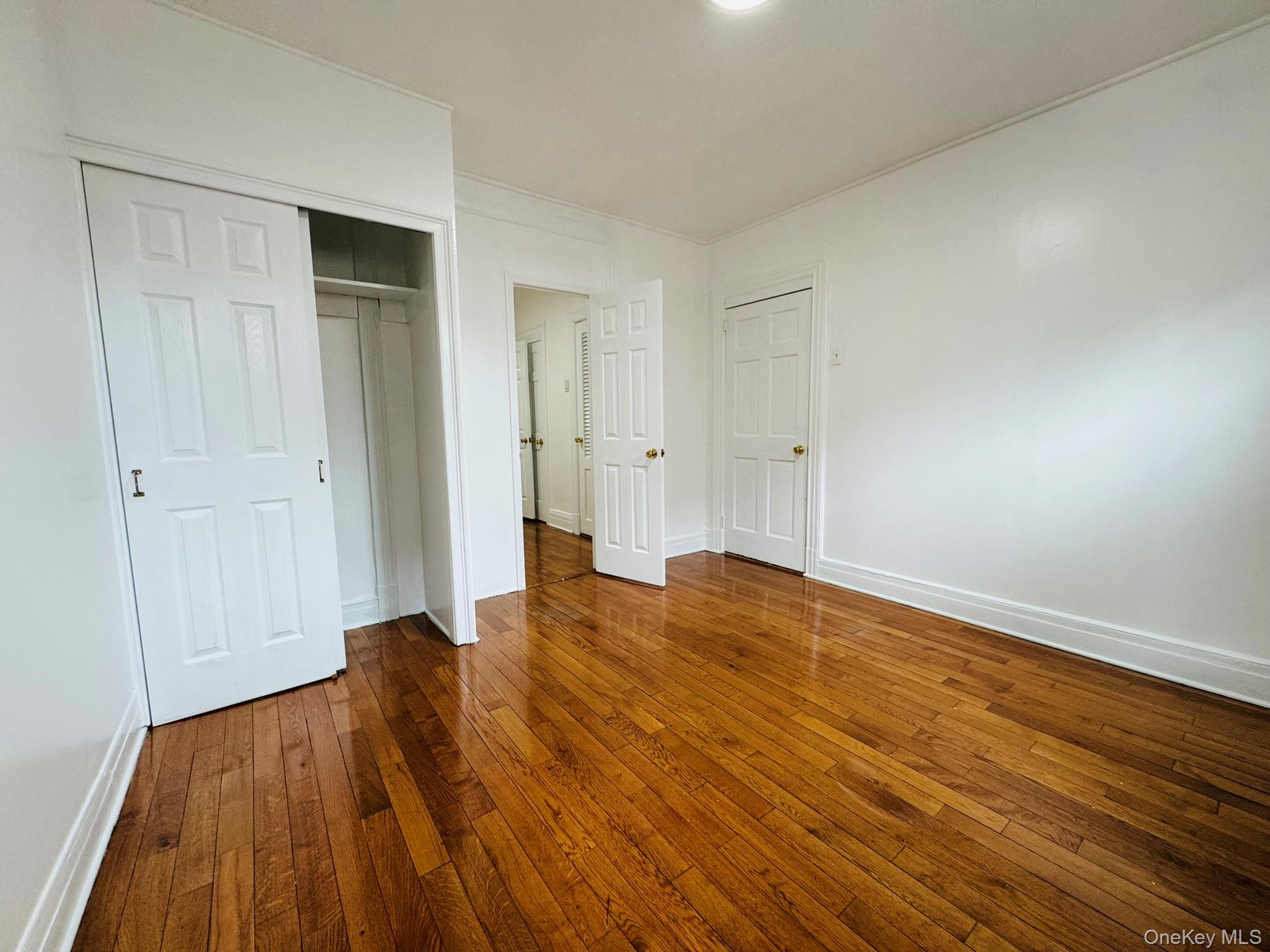 25-38 22nd Street, Unit 1 Queens, NY 11102 - Photo 8 of 19 a view of a room with wooden floor and bench