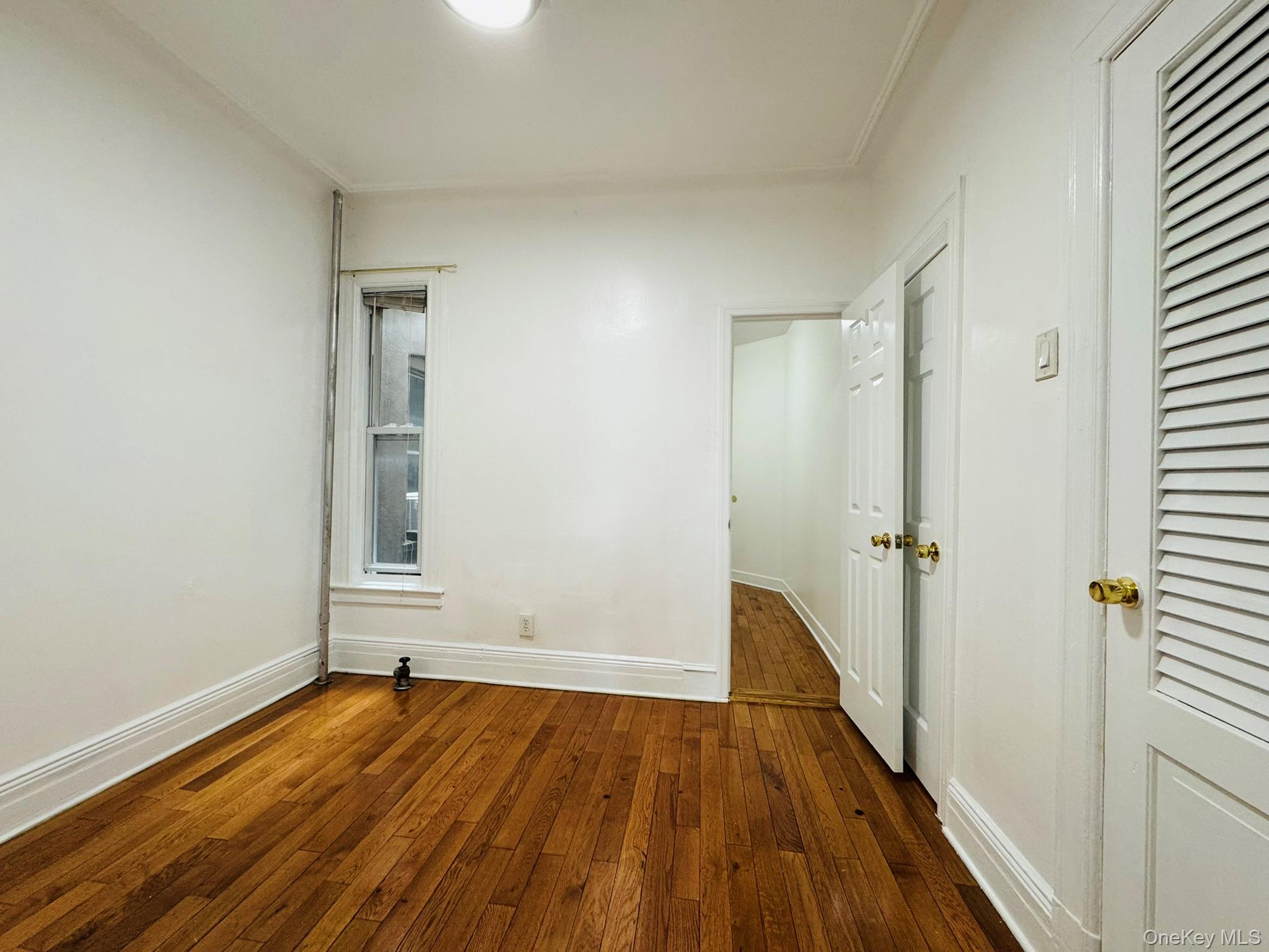 25-38 22nd Street, Unit 1 Queens, NY 11102 - Photo 10 of 19 wooden floor in an empty room