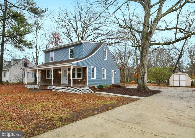 a front view of a house with a yard covered with snow