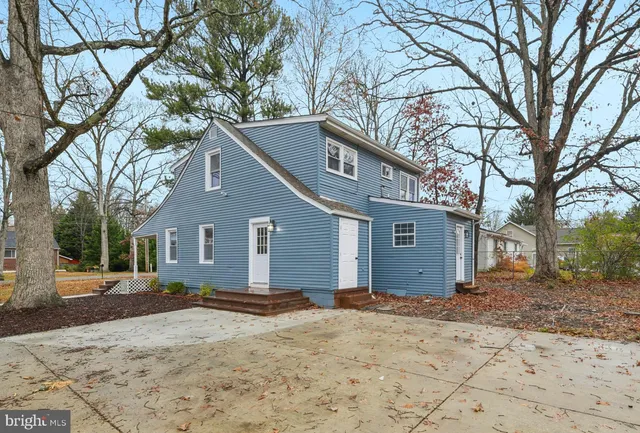 a front view of a house with a yard covered in snow