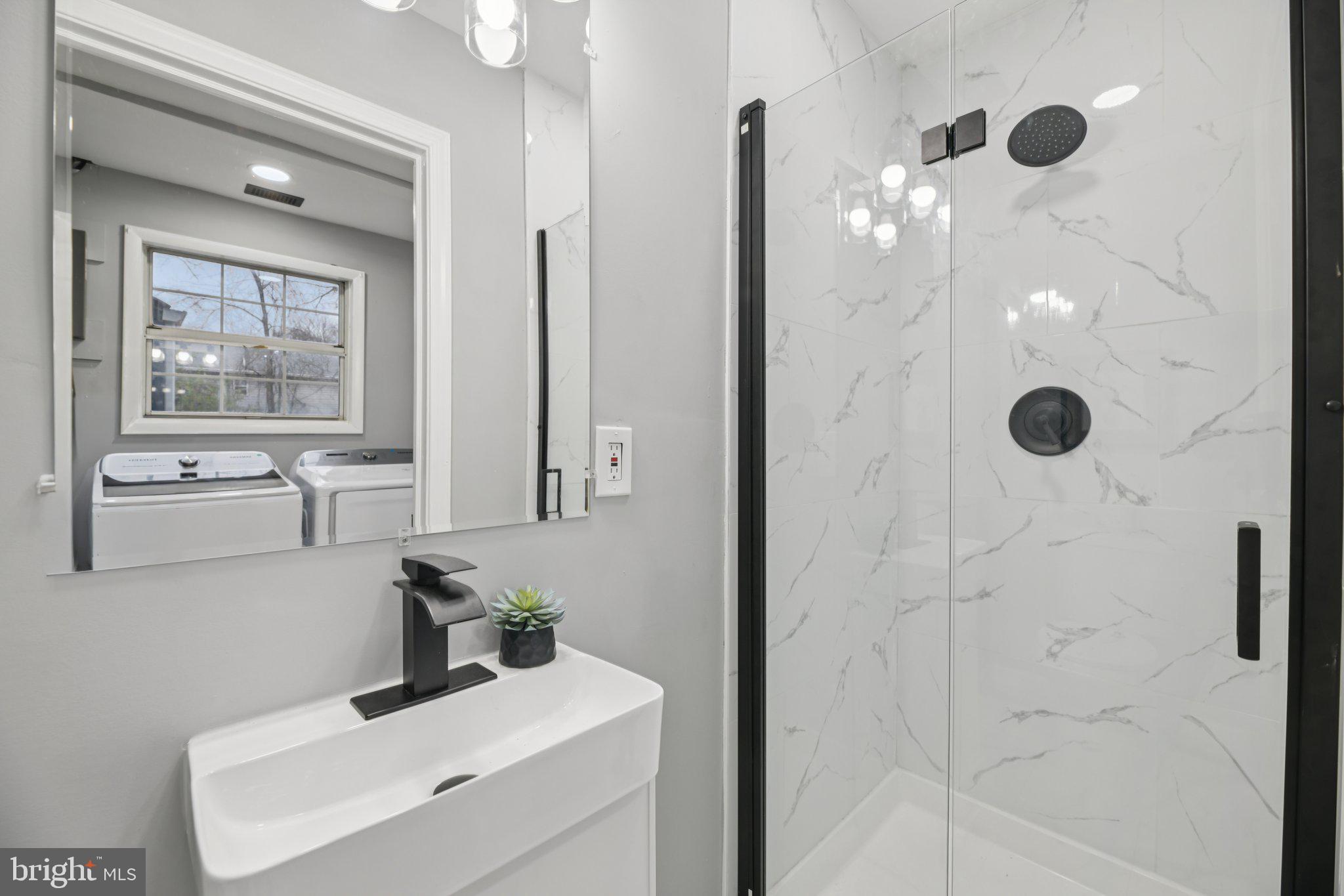 14610 Brandywine Heights Road Brandywine, MD 20613 - Photo 9 of 25 a bathroom with a sink a toilet and shower