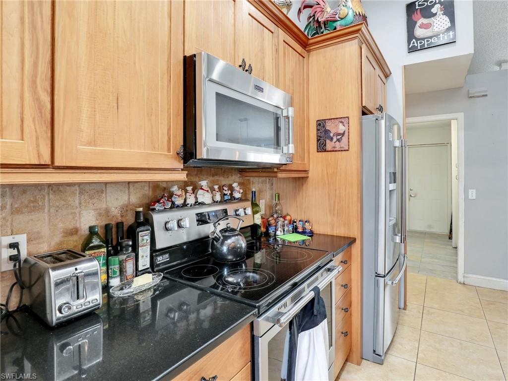 9083 Aster Road Fort Myers, FL 33967 - Photo 14 of 30 a kitchen with a stove and a sink